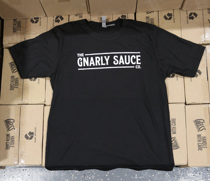 Black t-shirt with 'The Gnarly Sauce Co.' logo in white on cardboard boxes